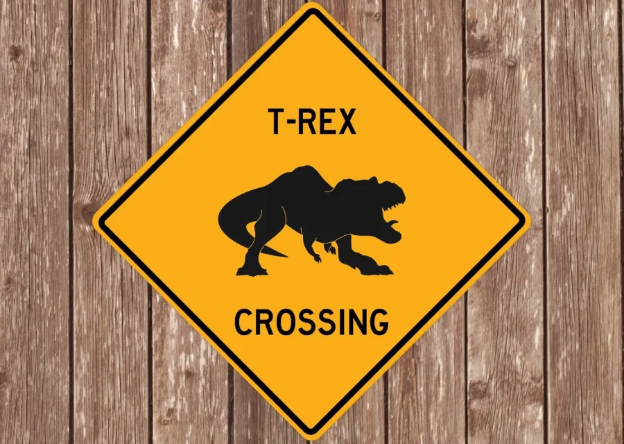 A Quirky Gift Co 'T-Rex Crossing' warning-style novelty sign.